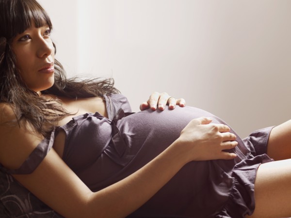 Pregnant mixed race woman relaxing