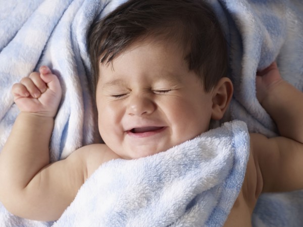 Mixed race baby boy laying on blanket