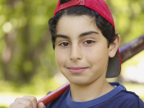 Mixed race boy holding baseball bat