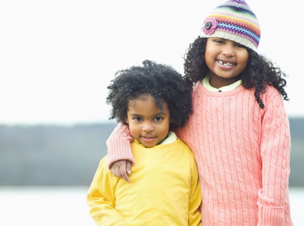 Mixed race children posing outdoors