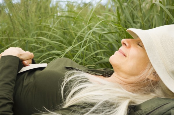 Smiling Caucasian woman sleeping in grass