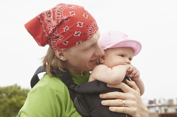 Father carrying baby outdoors
