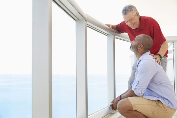 Father and son standing on balcony