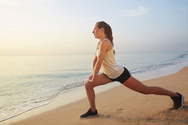 Athlete stretching on beach