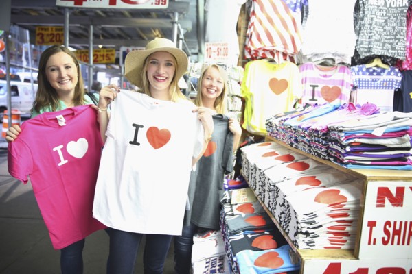 Portrait of smiling Caucasian woman showing t-shirts