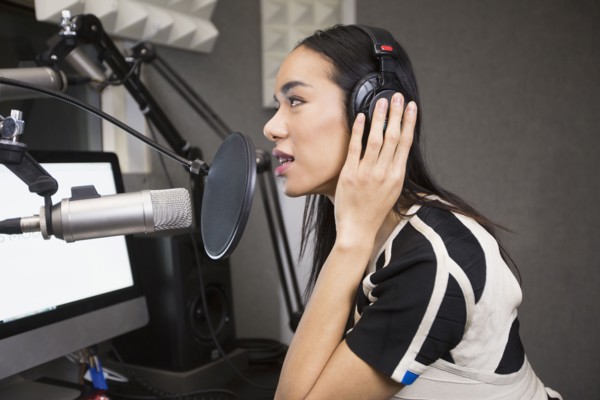 Thai transgender woman using headphones and microphone