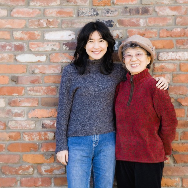 Asian mother and adult daughter hugging