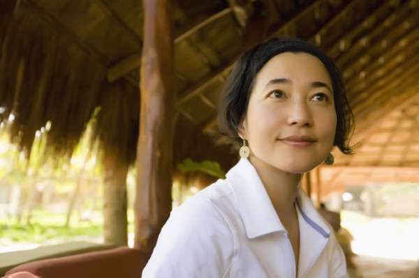 Asian woman sitting in hut