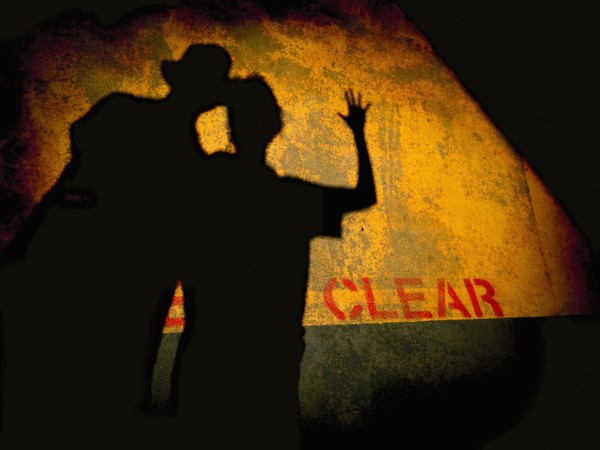 Shadow of couple on dilapidated wall