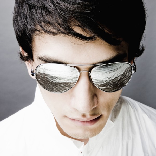 Mixed race man in sunglasses reflecting water