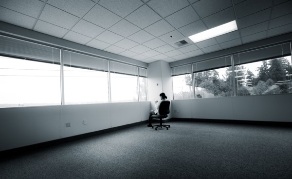 Japanese businesswoman sitting in corner of empty office