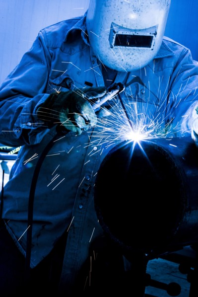 Caucasian welder working in factory