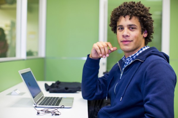 Mixed Race student using laptop in library