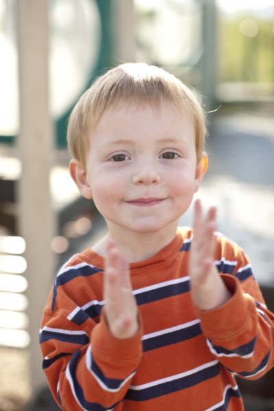 Caucasian boy clapping his hands