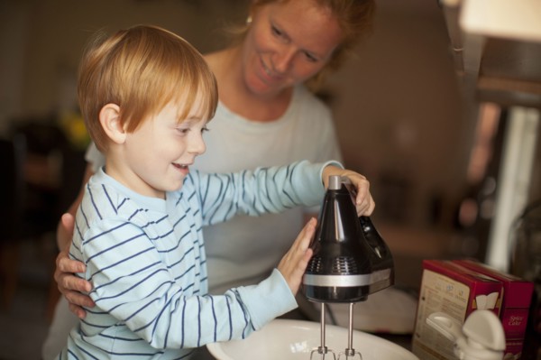 Caucasian mother and son baking in kitchen