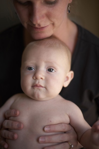 Caucasian mother sitting with baby