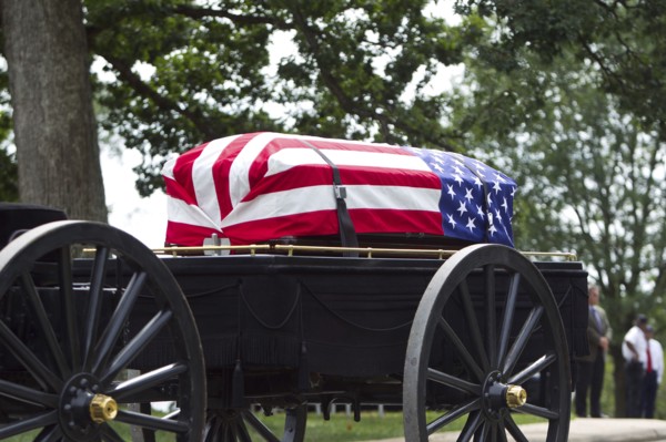American flag over casket at military funeral