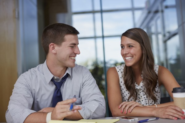 Business people laughing in office meeting