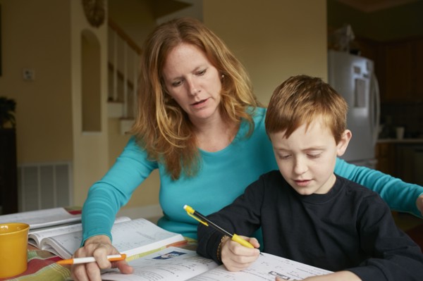 Caucasian mother helping son do homework