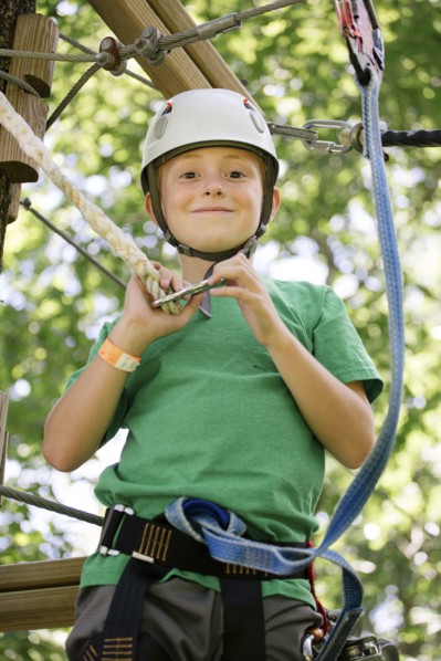 Caucasian boy hooking harness to line