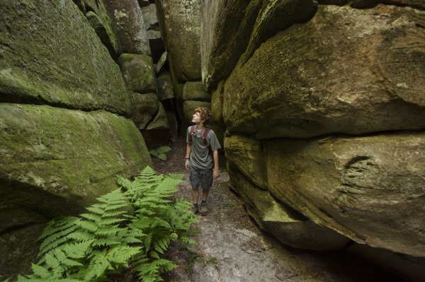 Caucasian teenage boy exploring cave