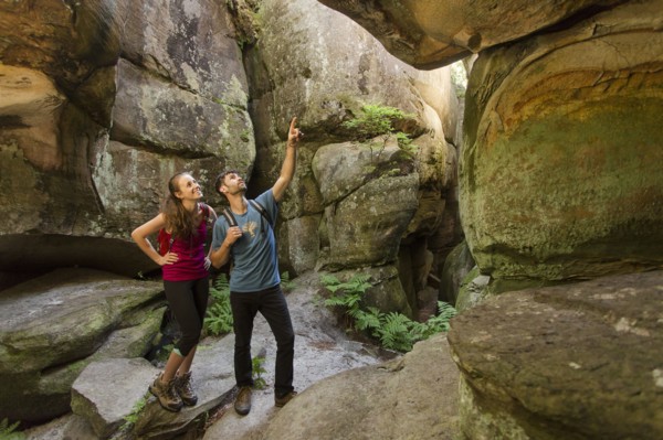 Caucasian couple exploring cave