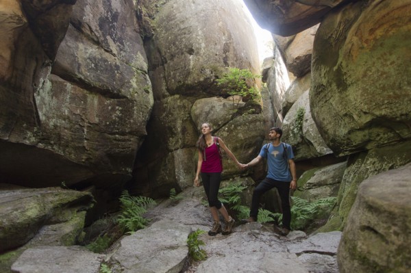 Caucasian couple exploring cave