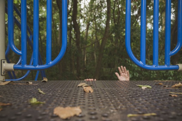 Hands of Hispanic girl reaching on playground