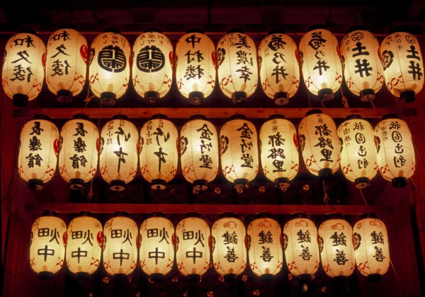Rows of illuminated prayer lanterns at night
