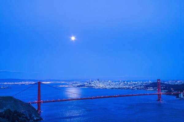 Moon in night sky over Golden Gate Bridge