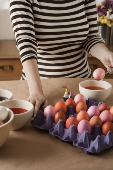 Woman dying Easter eggs
