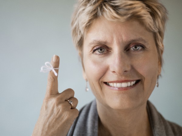 Caucasian woman with string tied on her finger