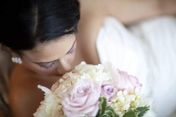 Egyptian bride smelling bouquet