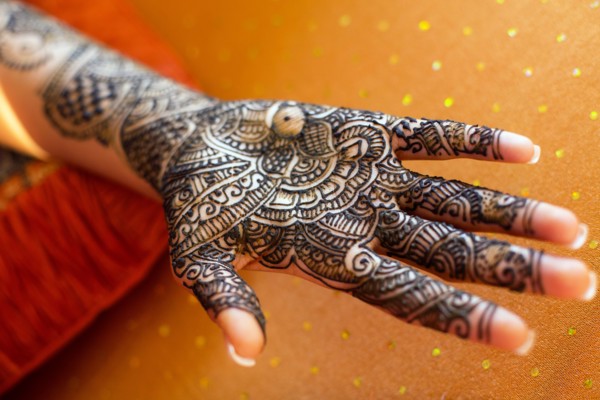 Close up of hand with intricate henna design