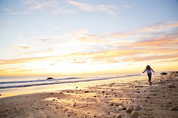 Caucasian woman walking on beach