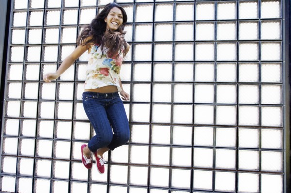 Hispanic teenager jumping in air