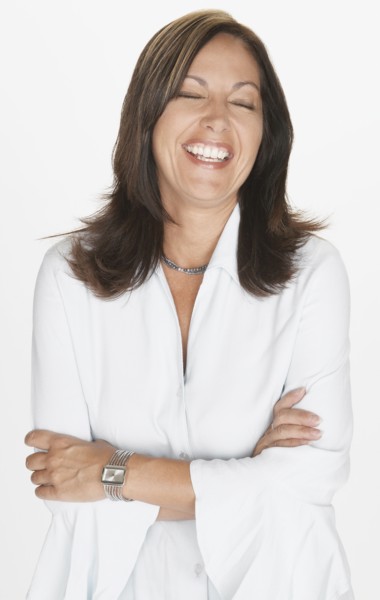Portrait of Hispanic woman laughing with eyes closed