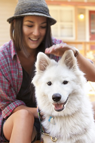 Woman petting dog outdoors