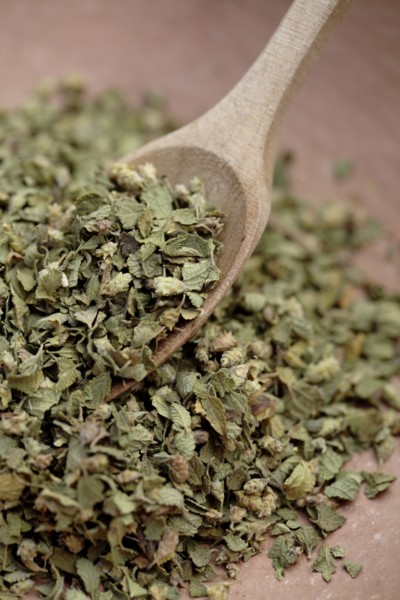 Close up of Mexican oregano and wooden spoon