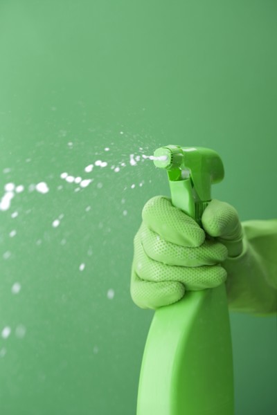 Green rubber glove squiring spray bottle