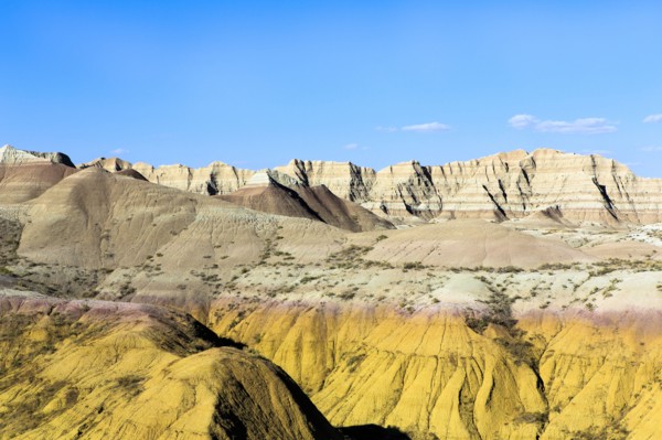 Layered rock formations under blue sky