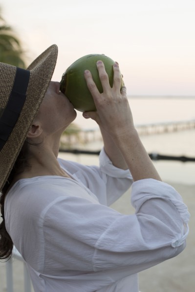 Caucasian woman drinking juice from coconut
