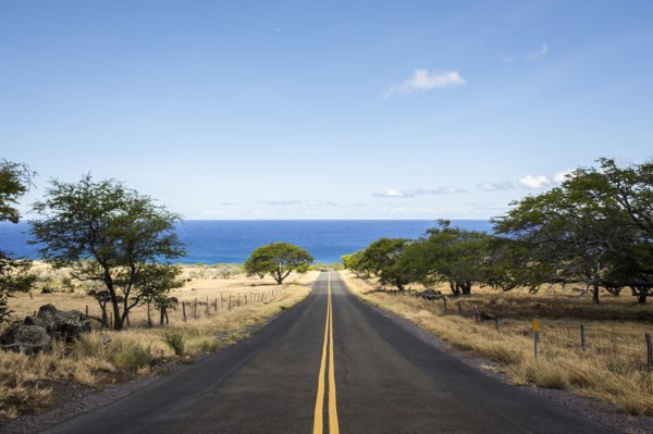 Empty road leading to ocean