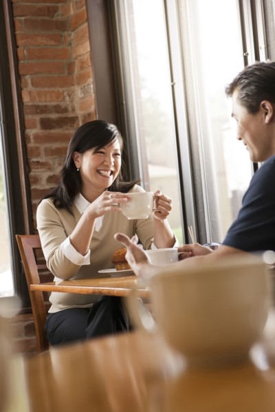 Chinese couple relaxing in cafe