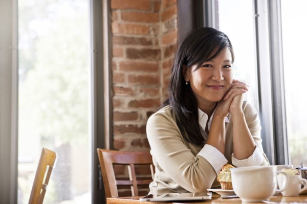 Chinese woman drinking coffee in cafe