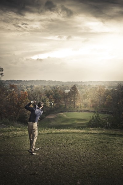 Caucasian man playing golf