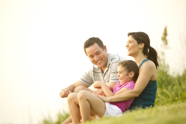 Family sitting in grass together