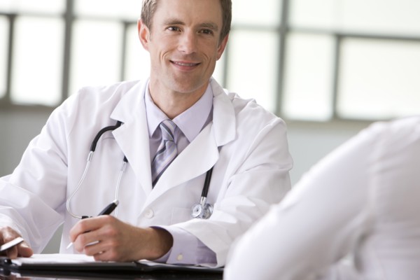 Caucasian doctor talking to patient