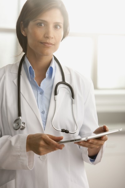 Hispanic doctor using digital tablet