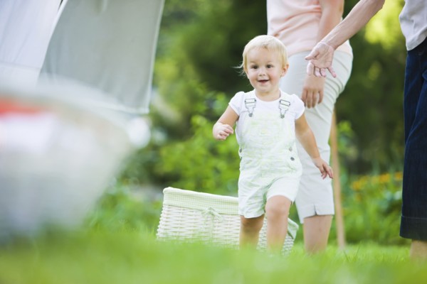 Caucasian baby running in grass